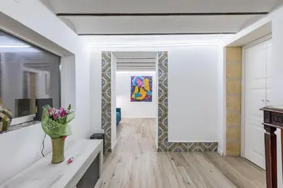 a hallway with a table and a painting on the wall at GuestHost - Palermo Modern and Central Apartment x6 in Palermo