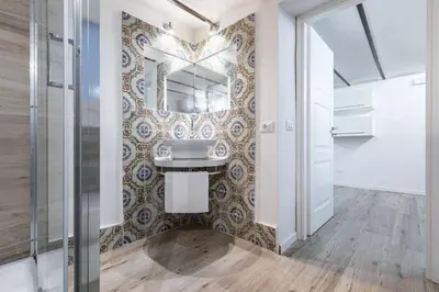 a bathroom with a sink and a mirror at GuestHost - Palermo Modern and Central Apartment x6 in Palermo