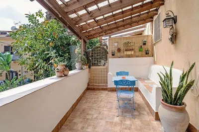 a balcony with a table and plants on it at CASA ARANCIO in Palermo