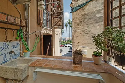 a balcony with potted plants on a building at CASA ARANCIO in Palermo
