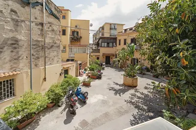 an overhead view of motorcycles parked in a courtyard at CASA ARANCIO in Palermo