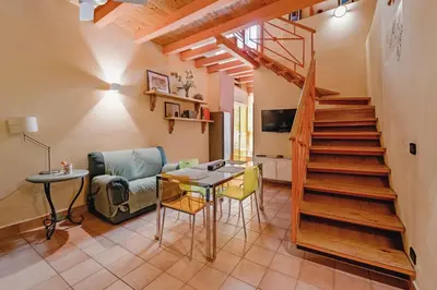a living room with a staircase and a table and chairs at CASA ARANCIO in Palermo