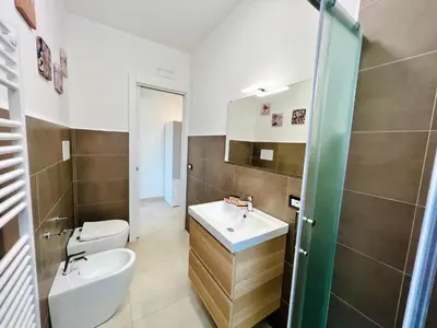 a bathroom with a toilet and a sink at Meravigghia in Terrasini