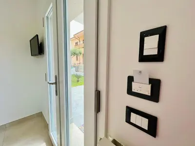 a glass door with a mirror on a wall at Meravigghia in Terrasini