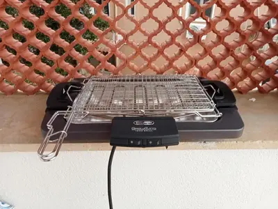 a charcoal grill sitting on a counter next to a wall at Casa Mare me' in Mondello