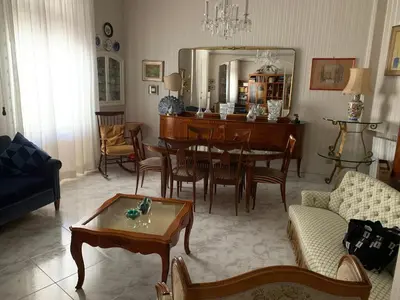 a living room with a table and a dining room at Materesa in Palermo