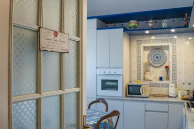 a doll house kitchen with a table and a sign at Materesa in Palermo