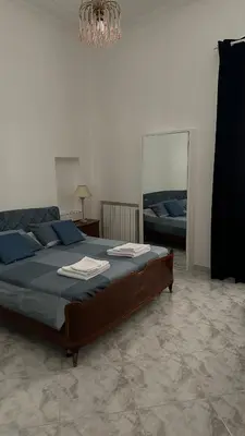 a bedroom with a large bed with a mirror at Materesa in Palermo