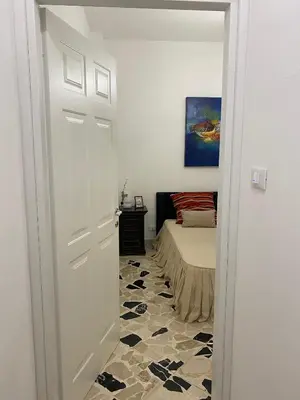 a white door leading to a bedroom with a bed at Holiday & House - Imparato Carini Costa Verde - Appartamento con giardino privato - porzione di Villa residenziale a pochi passi dal mare in Carini