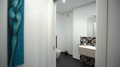 a bathroom with a sink and a toilet and a mirror at Mi Tierra Luxury Apartments in Palermo