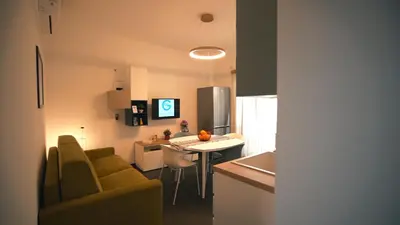 a kitchen and living room with a table and chairs at Mi Tierra Luxury Apartments in Palermo