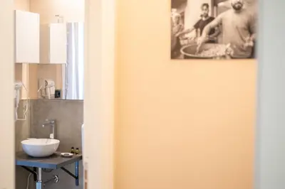a bathroom with a white sink on a counter at I Quattru Vuci Rooms in Palermo