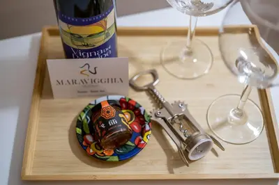 a wooden table with a pen and a map at I Quattru Vuci Rooms in Palermo