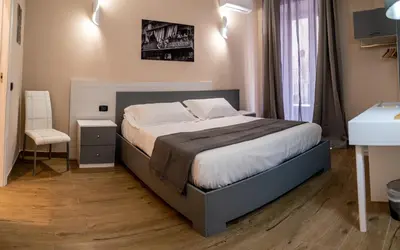 a bedroom with a large bed in a room at I Quattru Vuci Rooms in Palermo