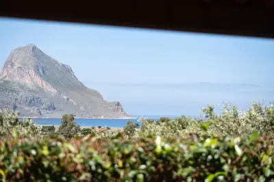 a view of the ocean and a mountain at Villa Premiere immersa nel verde a Castelluzzo in Castelluzzo