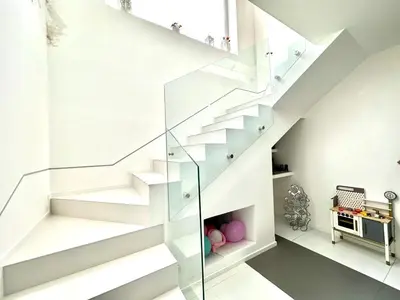 a white staircase with glass railing in a house at Villa Eirene in Termini Imerese