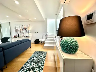 a living room with a couch and a lamp on a table at Villa Eirene in Termini Imerese