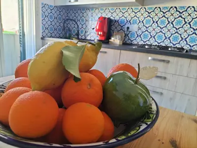 a bowl of fruit on a table in a kitchen at InCentro Palermo in Palermo