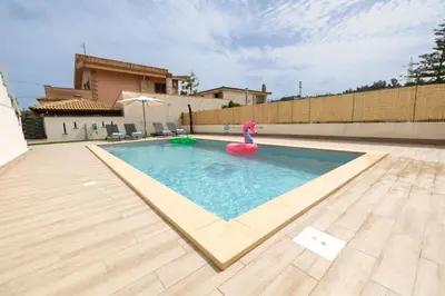 a swimming pool with a pink flamingo in a house at Villa Portofino - Private pool in Campofelice di Roccella