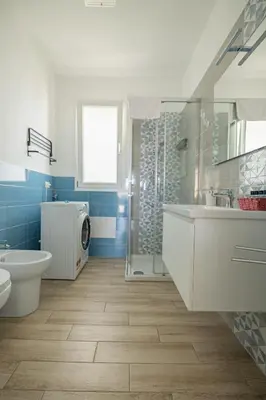a bathroom with a toilet sink and a shower at Villa Portofino - Private pool in Campofelice di Roccella