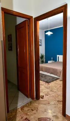 an open door to a bedroom with a bed at Amaryllis Apartments in Bagheria