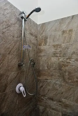 a shower with a shower head in a bathroom at Amaryllis Apartments in Bagheria