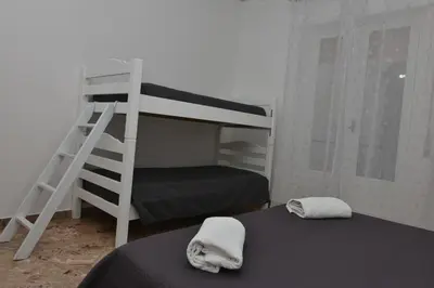 a bedroom with a bunk bed and a ladder at Amaryllis Apartments in Bagheria