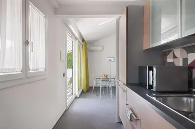 a kitchen with a sink and a microwave at Archimedes luxury apartment with terrace in Palermo