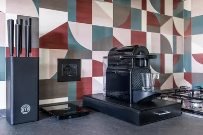 a coffee maker sitting on a counter in a kitchen at Archimedes luxury apartment with terrace in Palermo