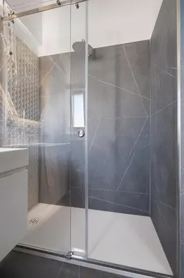 a shower with a glass door in a bathroom at Archimedes luxury apartment with terrace in Palermo