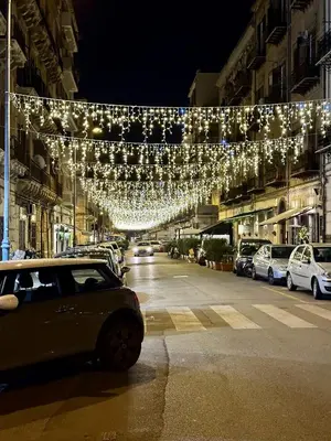 a car parked on the side of a street with lights at Archimedes luxury apartment with terrace in Palermo