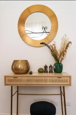 a mirror on top of a table with a fireplace at Doma in Palermo