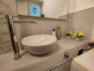 a white bowl on a counter in a bathroom at Casa Lia al centro di palermo in Palermo