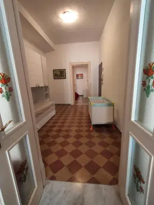 a hallway with a room with a checkerboard floor at Casa Lia al centro di palermo in Palermo