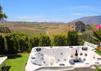 a bath tub with a glass of wine and a view at Villa Finestra sul Castello in Partinico