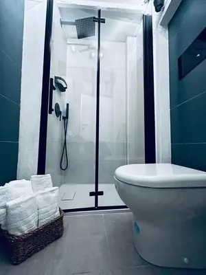 a bathroom with a shower and a toilet and towels at CasaCecè kalsa in Palermo