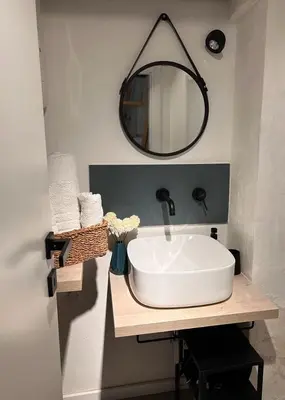 a bathroom with a white sink and a mirror at CasaCecè kalsa in Palermo