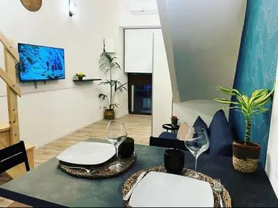 a living room with a table and two wine glasses at CasaCecè kalsa in Palermo