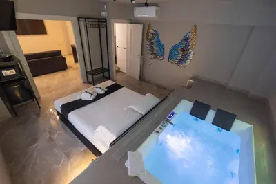 a room with a bed and a swimming pool at Maximum Exclusive Suite & Spa in Palermo