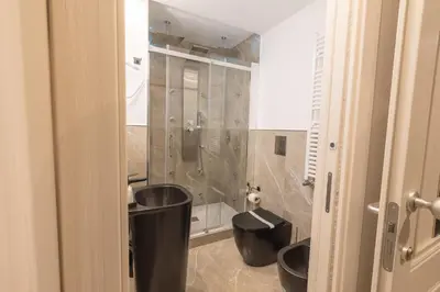 a bathroom with a shower and a toilet in it at Maximum Exclusive Suite & Spa in Palermo