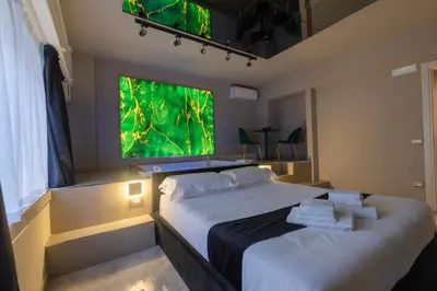 a bedroom with a large window and a large bed at Maximum Exclusive Suite & Spa in Palermo