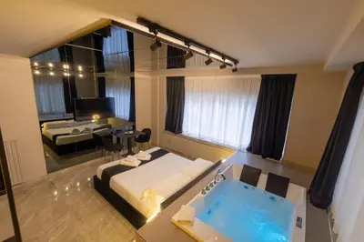 a large bathroom with a tub in the middle of a room at Maximum Exclusive Suite & Spa in Palermo