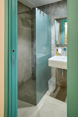 a bathroom with a glass shower and a sink at La casa di Chele in Palermo