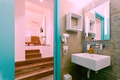 a bathroom with a sink and a mirror at La casa di Chele in Palermo