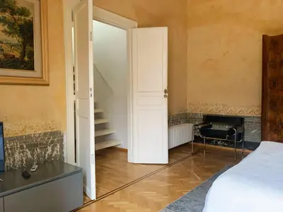 a room with a bed and a door and a staircase at Appartamento Al Genio in Palermo