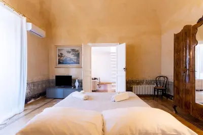 a bedroom with a bed and a television in it at Appartamento Al Genio in Palermo