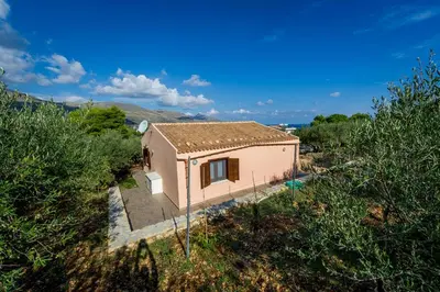 a small house in the middle of a field at Casetta degli Ulivi Castellammare del Golfo in Scopello