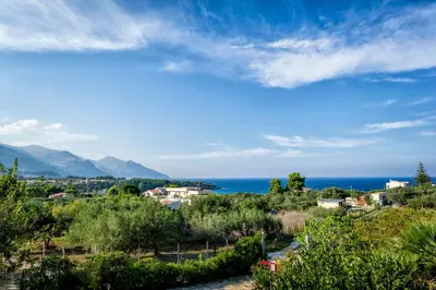 a view of a town and the ocean at Casetta degli Ulivi Castellammare del Golfo in Scopello