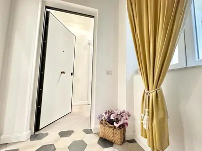 a hallway with a mirror and a basket of flowers at PALAZZO LA ZAGARA in Palermo