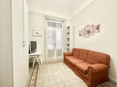 a living room with a couch and a desk at PALAZZO LA ZAGARA in Palermo